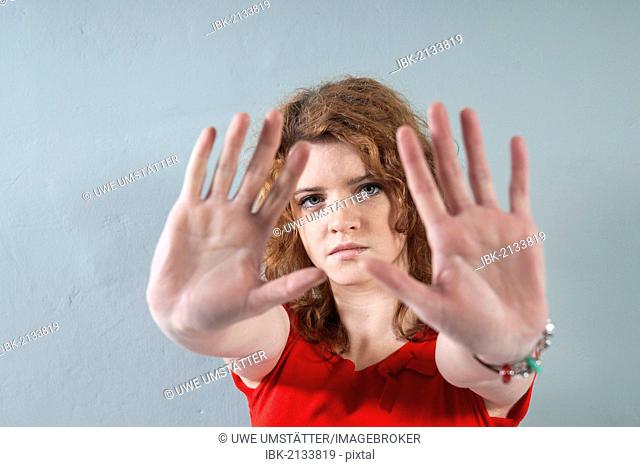 Girl with her hands stretched out in a defensive position