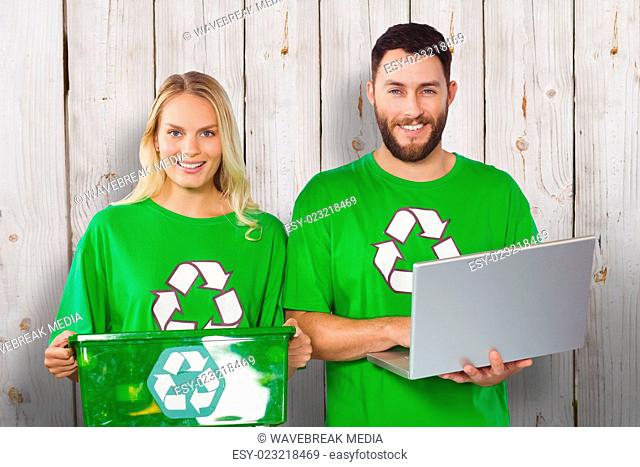 Composite image of portrait of smiling volunteers in recycling symbol tshirts