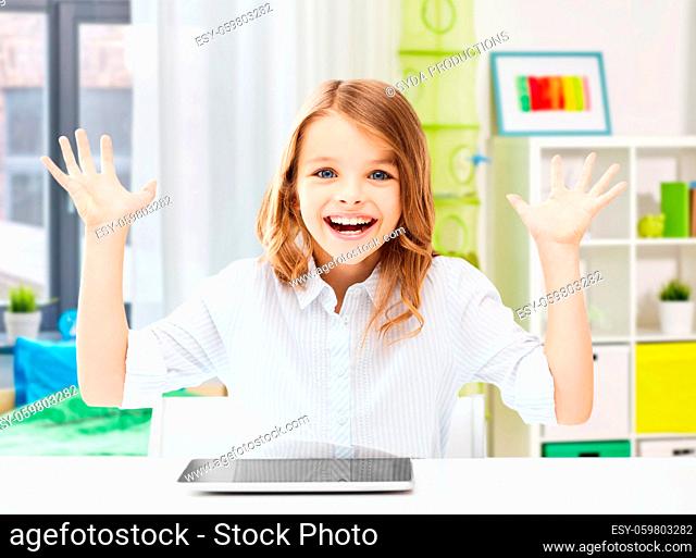 happy laughing student girl with tablet pc at home