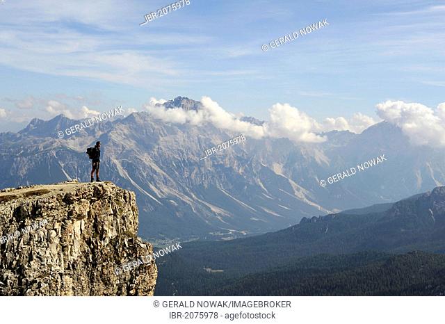 Mountaineer on the summit of Mt Kleiner Lagazuoi with mountain panorama, Dolomites, South Tyrol, Italy, Europe