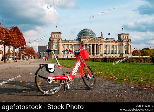 Berlin, germany - October - 2019: Bike sharing bicycle Jump by Uber in front of the Reichstag building in Berlin