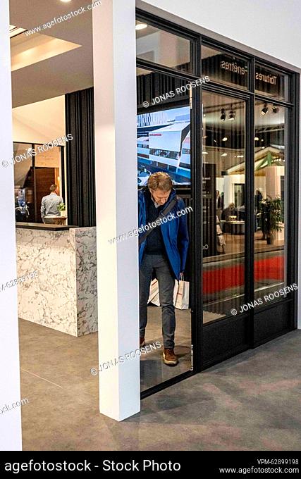 Illustration picture shows a man looking at a door frame during the opening day of the 2023 edition of Batibouw, the annual building