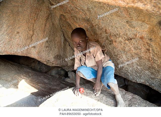 A boy hides in a cave near Kauda, Sudan, 12 February 2017. The caves offer the population a refuge from the government's air force