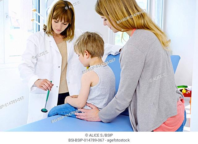 Doctor testing a child's knee jerk reflex