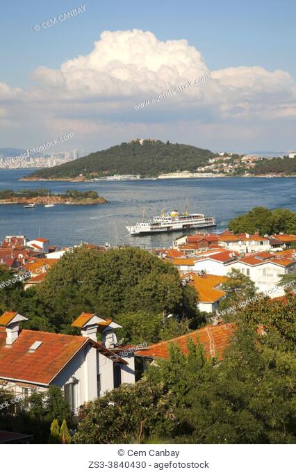 View from a hill in Burgazada, ancient Antigoni to the Heybeliada-Halki with a traditional ferry in the foreground, Prince Islands, Istanbul, Marmara Region