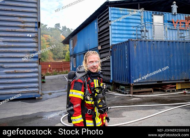 Smiling firefighter looking at camera