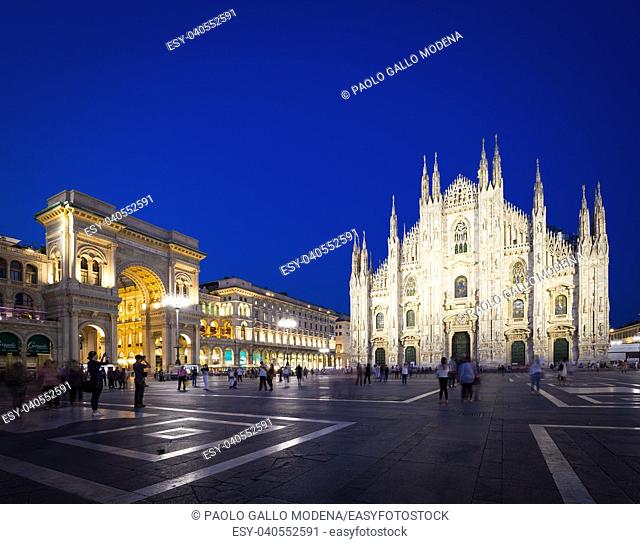 MILAN, ITALY - APRIL 28th, 2018: turists during blue hour taking pictures in Duomo Square , the main landmark of the city