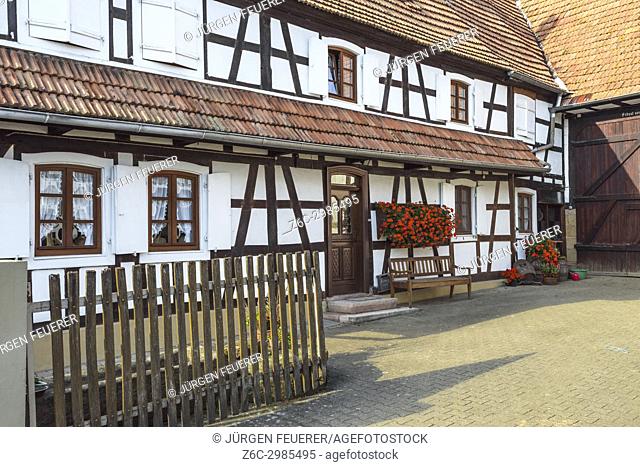half-timbered houses with flower decoration in Hunspach, small village in Northern Alsace, North Vosges, France, member of the most beautiful villages of France
