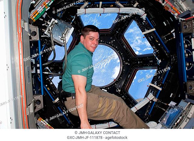 NASA astronaut Robert Behnken, STS-130 mission specialist, is pictured near the windows in the Cupola of the International Space Station while space shuttle...