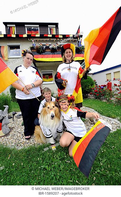 Fans of the German national team in German team jerseys and with national flags in front of a decorated house, Stuttgart, Baden-Wuerttemberg, Germany, Europe