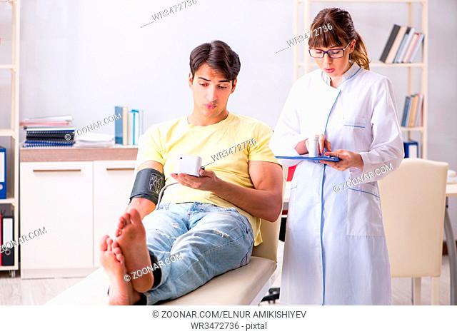 Young doctor checking patients blood pressure