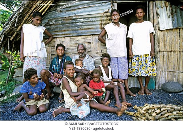 Portrait of a family gathered outside their home, Sulphur Bay Village, Ipekel Ipeukel, Tanna Island, Vanuatu
