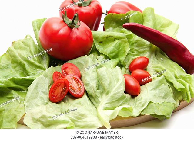 Tomatoes on salad leaf