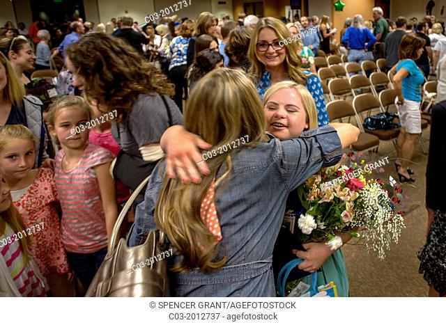 A handicapped Adult Transition Program (ATP) student is congratulated by mother at her graduation in San Juan Capistrano, CA
