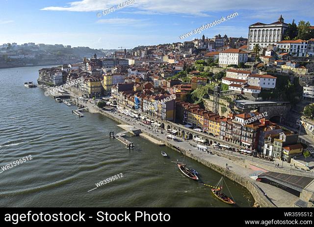 High angle view of coastal town with sailboat moored near harbour wall, Portugal