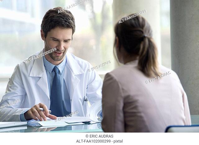 Doctor meeting with patient in office