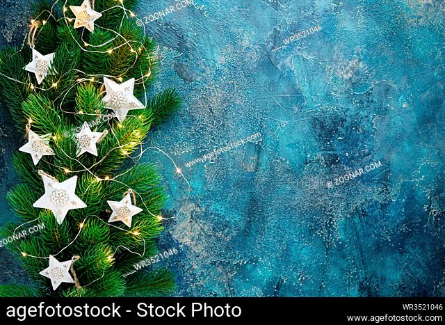 Christmas holiday frame with festive decorations - white metal hearts and old pjcket wathes on old blue background. Christmas background with copy space