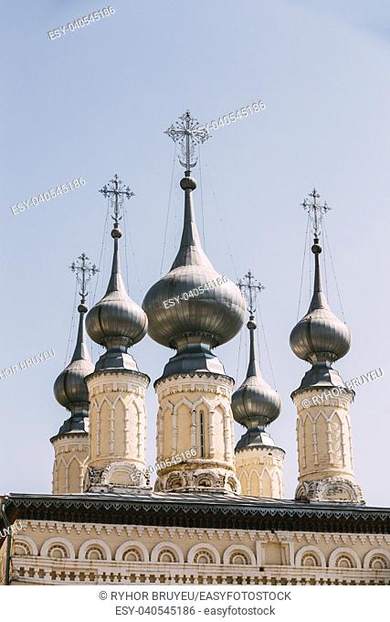 Domes of the Smolensk temple church against blue sky in Suzdal, Russia