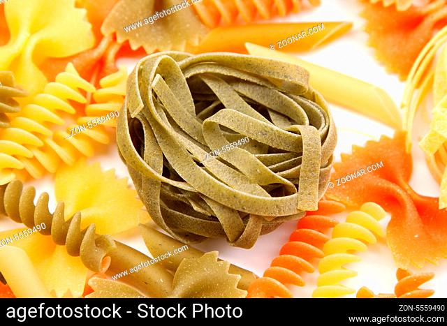 Green tagliatelle paglia e fieno on the backgroun of different pastas