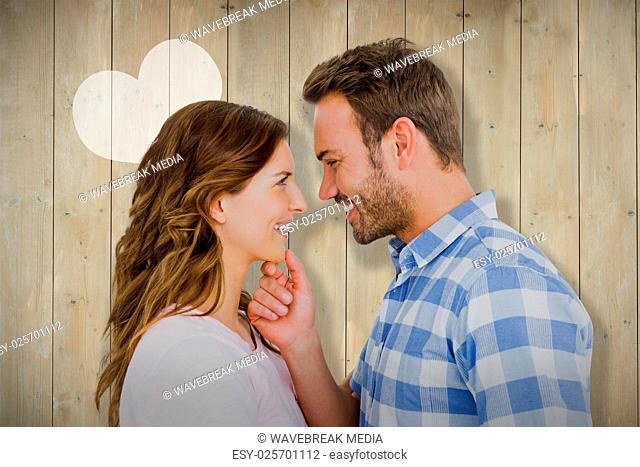 Composite image of happy young couple looking at each other and smiling