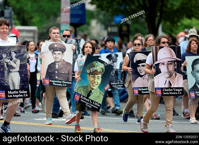 Washington, D.C., USA - May 28, 2018: The National Memorial Day Parade, People carry portraits of world war two military personel down constitution avenue
