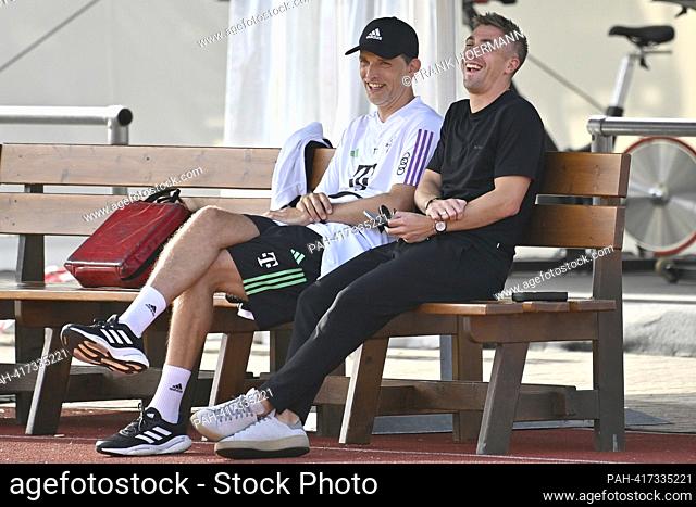 Coach Thomas TUCHEL (FC Bayern Munich) and Marco NEPPE (Technical Director FCB) sit amused on a wooden bench, test match FC Bayern Munich - Rottach Egern 27-0...