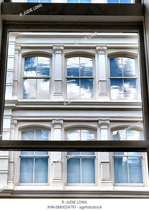 Soho Windows. Looking Out of a Modern Window, Seeing Windows of an Old Cast Iron Building, in the Soho Neighborhood of Manhattan, New York City