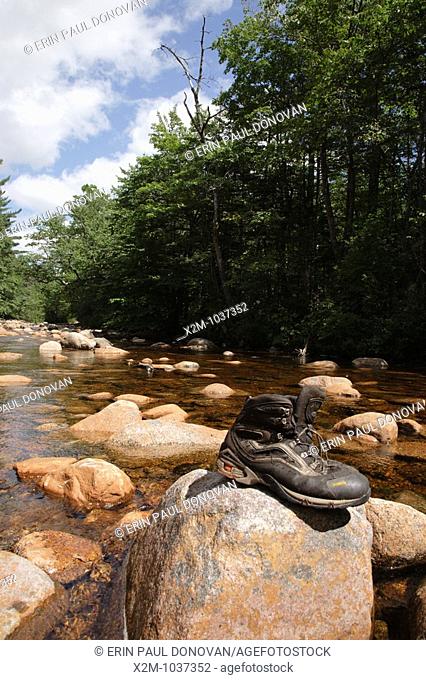 Pemigewasset Wilderness - Hiking boots drying off on rock along the North Fork East Branch Pemigewasset River during the summer months in Lincoln