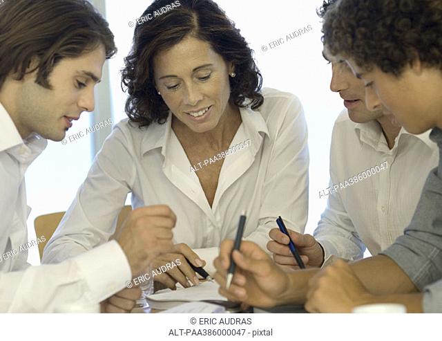 Business associates looking at document together
