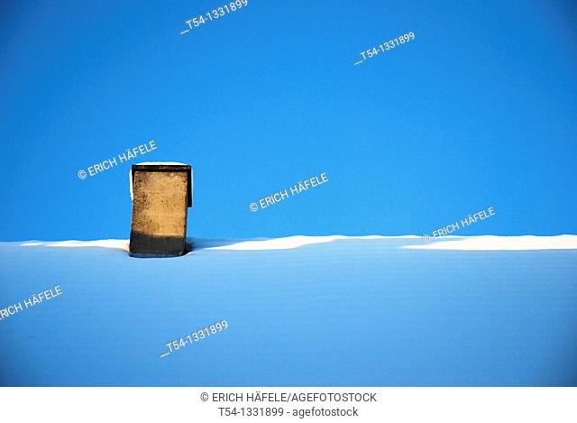 Chimney on a snow-covered roof