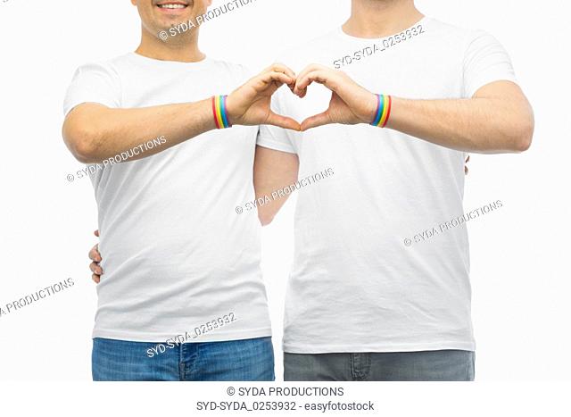 couple with gay pride rainbow wristbands and heart