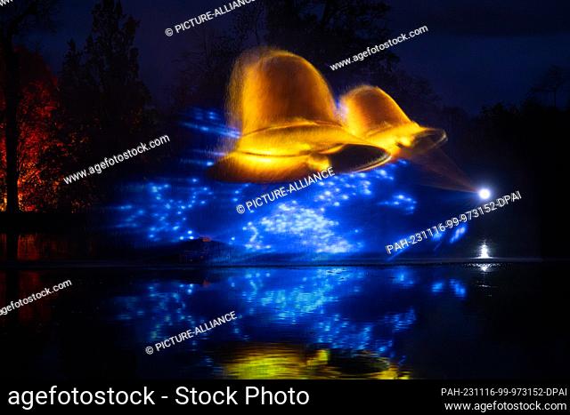 16 November 2023, Saxony, Dresden: Bells are projected into a fountain of water in the pleasure garden to mark the opening of the ""Christmas Garden"" light...