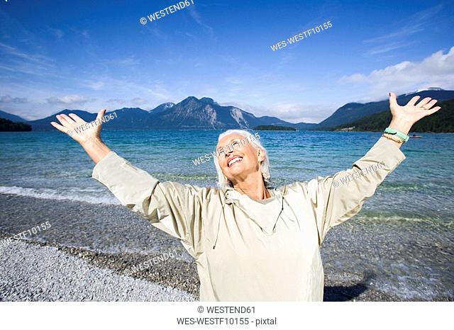 Germany, Bavaria, Walchensee, Senior woman, cheering