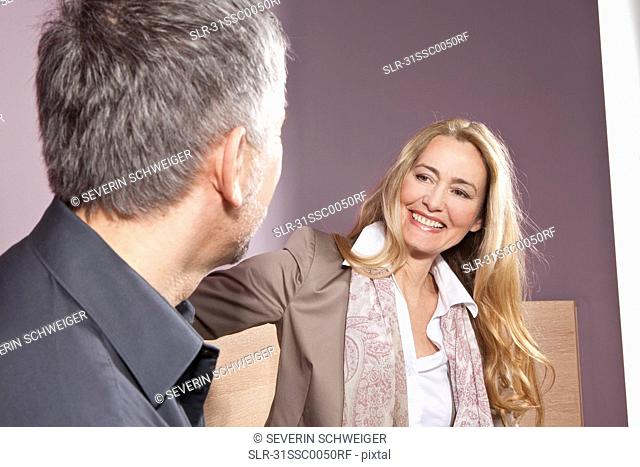 Middle aged woman smiling at man