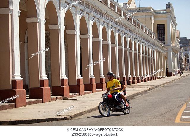 Motorcyclist in front of the arches near the Jose Marti Park, Cienfuegos, Cuba, West Indies, Central America
