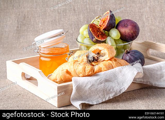 Breakfast with croissant and honey. Continental set