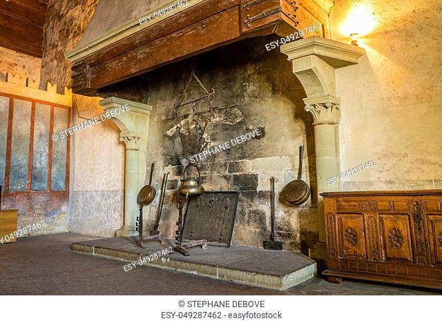 Fireplace in a castle with cooking ustensils ready to be used