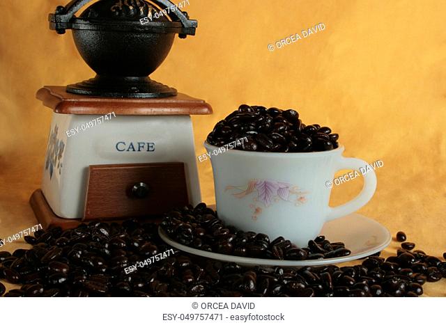 coffee beans in a mug on yellow backgroung