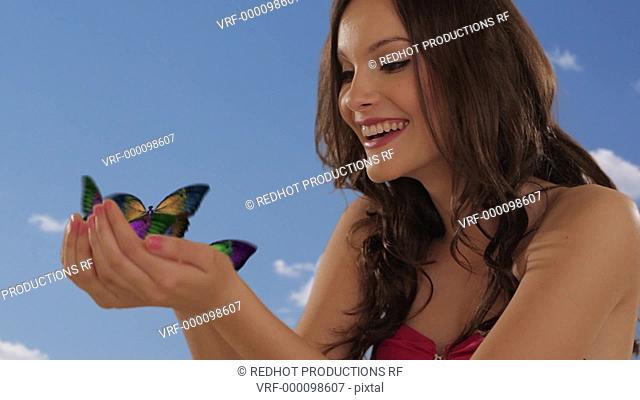 young girl with butterflies flying from hands
