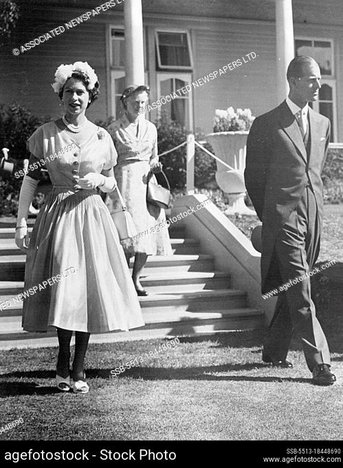 Queen Elizabeth and the Duke of Edinburgh arriving on the lawn at the Garden Party at Government House, Wellington, NZ. The Queen wore a frock of pale beige...