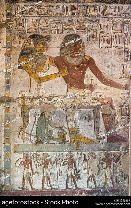 painted engravings of the tomb of Paheri, showing a small monkey (in blue) sitting under the couple. El Kab necropolis on the east bank of the Nile, Egypt