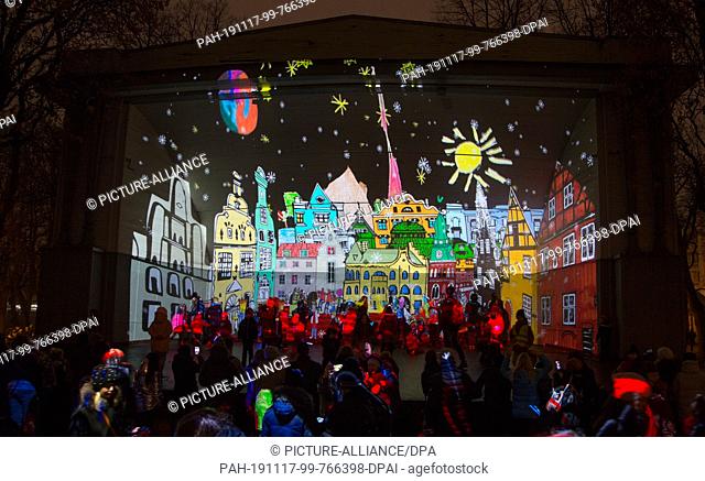 16 November 2019, Latvia, Riga: Video projection on a stage in a park. Latvia's capital Riga presents itself on the occasion of the national holiday on 18...