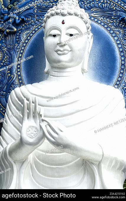 White buddha at the Blue Temple (Wat Rong Suea Ten or Temple of the Dancing Tiger) in Chiang Rai, Thailand, Asia. Blue is symbolically associated with purity