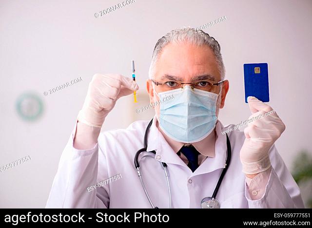 Old doctor in vaccination concept