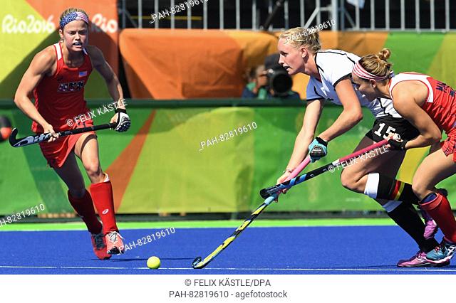 Hannah Krueger of Germany in action against Kathleen Sharkey (L) and Alyssa Manley of the USA during the Women's Field Hockey Quarterfinal match between the USA...