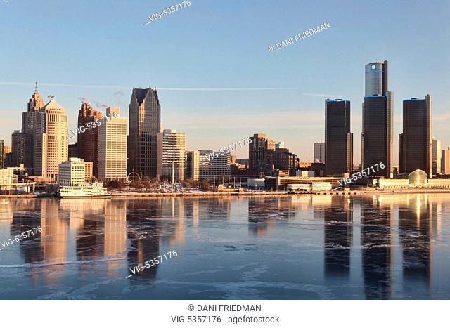 The skyline of Detroit, Michigan, USA with a thin sheet of ice on the Detroit River seen just after sunrise. Detroit's population has sunk to 700