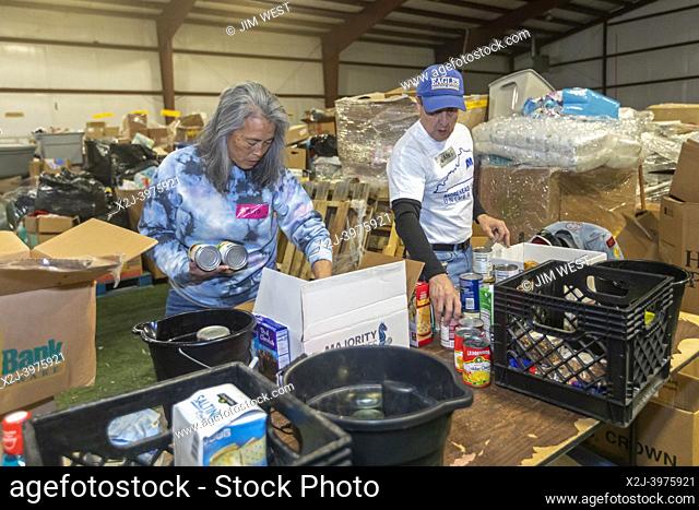 Mayfield, Kentucky - Volunteers sort donated food, clothing, and other supplies at the Tornado Relief Center at the Graves County Fairgrounds