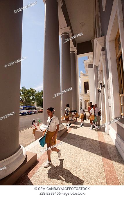 Female students at the entrance of the college building in Jose Marti Park, Cienfuegos, Cienfuegos Province, Cuba, West Indies, Central America