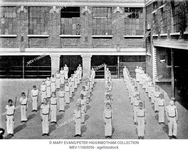 Boys performing a drill in the gymnasium at Barnardo's Leopold House Home, Limehouse, London