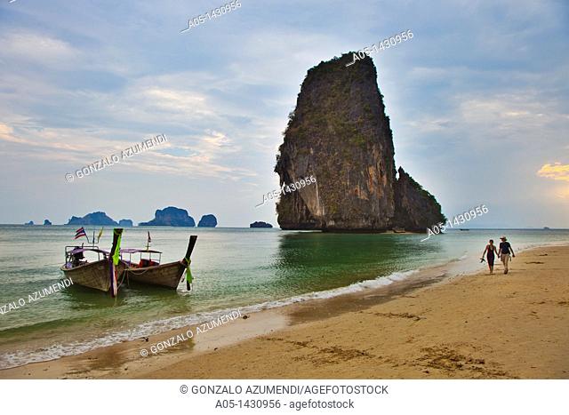 Rai Leh bay, Railay bay, Long-tail boat at the sandy Phranang Beach and limestone cliffs in the Andaman Sea Phranang Peninsula, Krabi province
